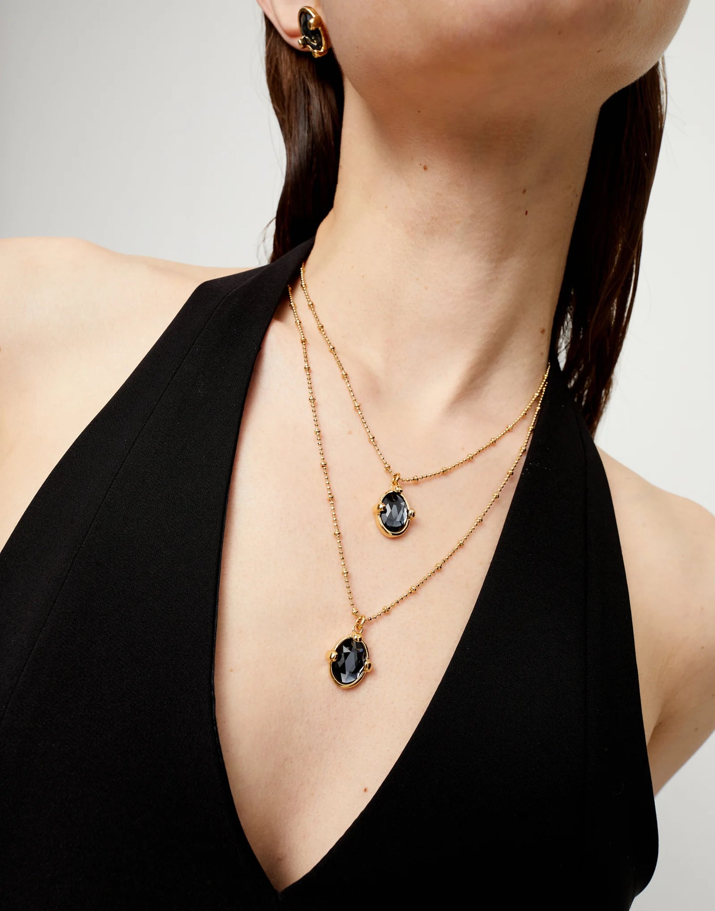 Multi strand necklace Gold with two black oval faceted crystals