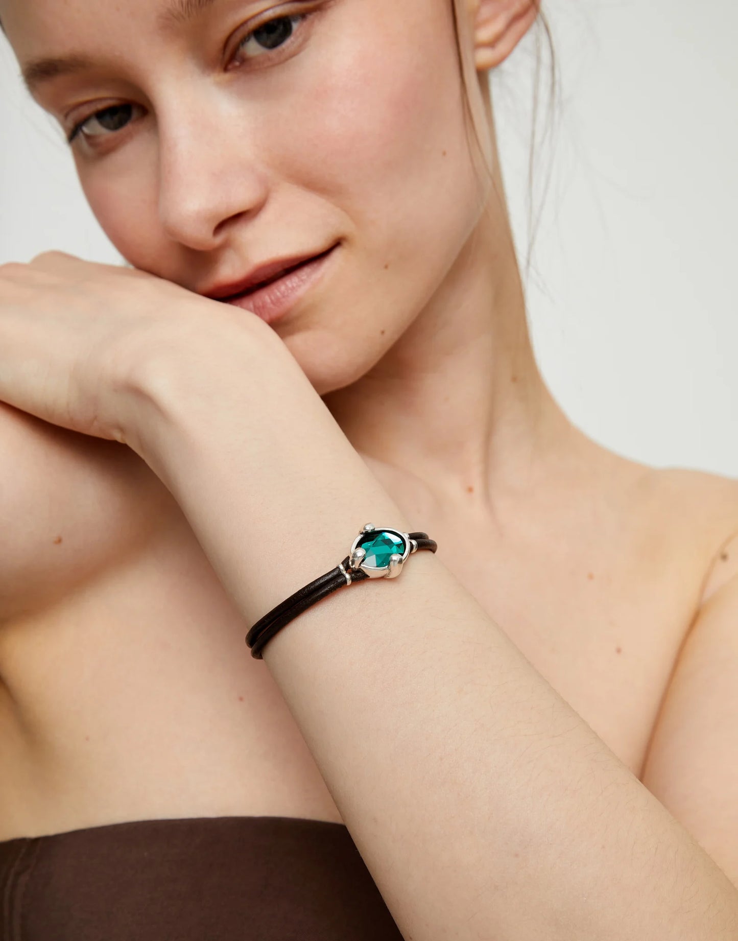 Leather bracelet with green oval faceted crystal