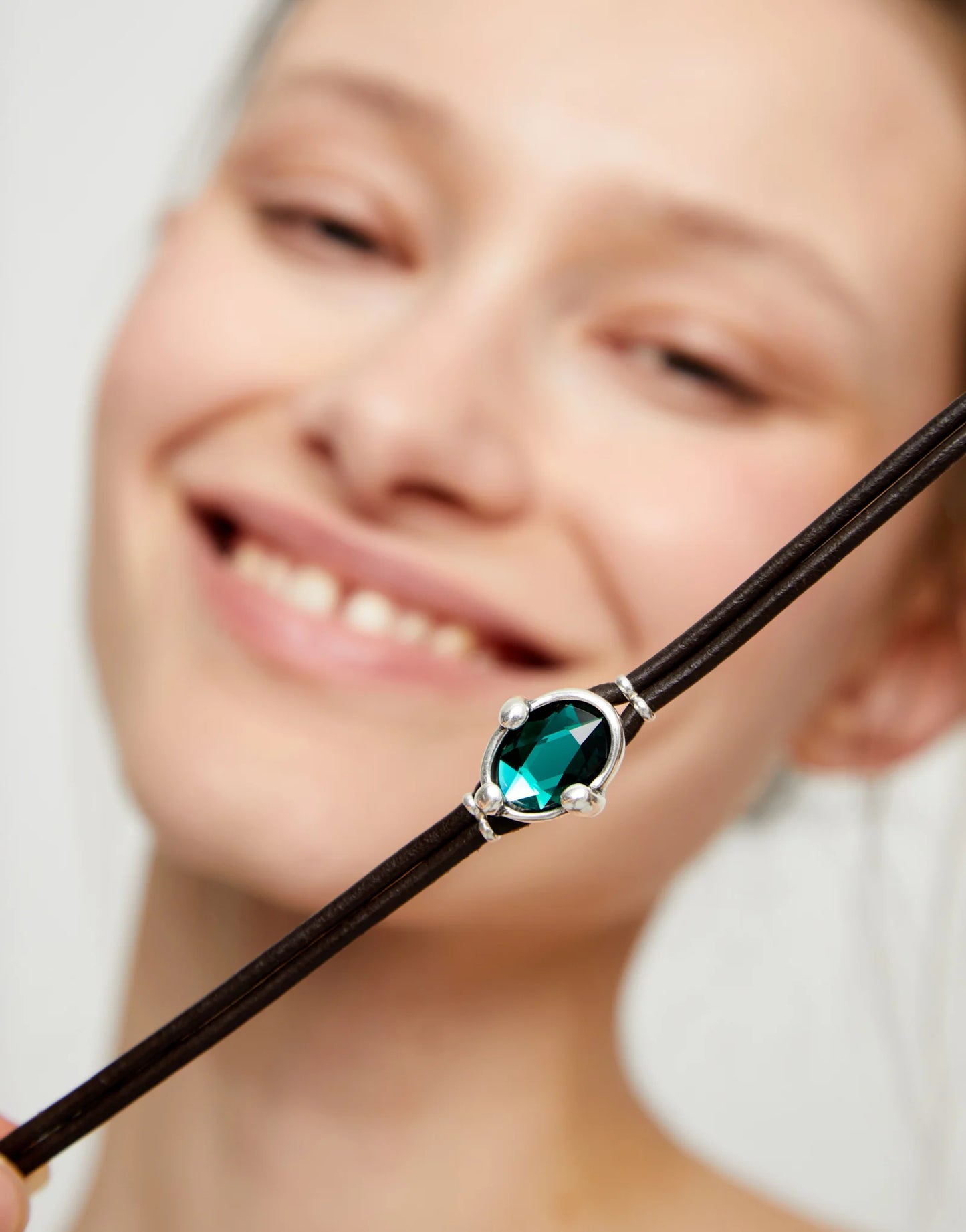 Leather bracelet with green oval faceted crystal