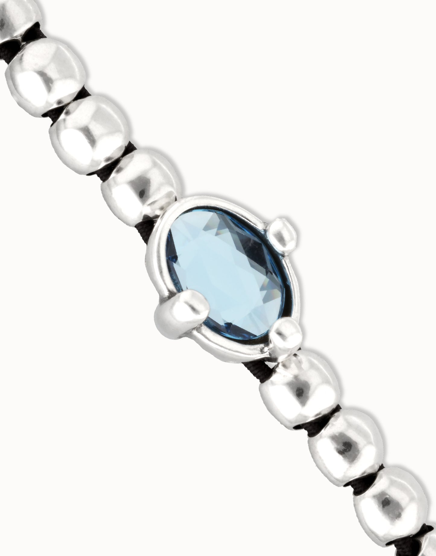Beaded bracelet with blue oval faceted crystal